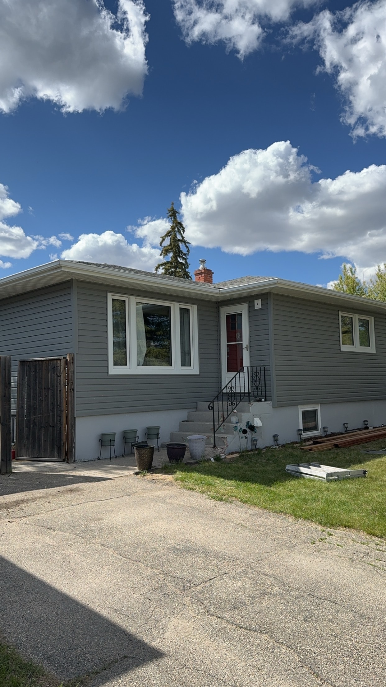 Grey vinyl siding completed house exterior Regina